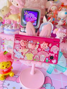 there are many toys on the table and one has a computer screen in front of it