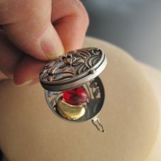 "Sterling silver wish/box/locket/prayer box pendant reveals a golden kidney and red glass heart inside. These are hand made cases by skilled artisans in Thailand. The surface is brushed to achieve a smooth matte surface that feels great in the hand. Th inside of the locket has been oxidized/darkened for contrast. It locks with a latch, as shown. The dimensional design is of Lotus flowers, which symbolize enlightenment and rebirth, two qualities that go hand in hand with transplants. My Golden Ki Antique Jewelry Gift With Box Clasp, Kidney Donor, Wish Box, Prayer Box, Lotus Flowers, Weird Shapes, Silver Lockets, Glass Heart, Butterfly Wings