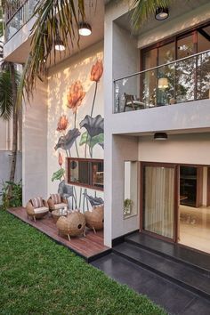 an outside view of a house with flowers painted on the wall