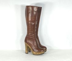 "1970s elegant brown leather platform boots by the popular maker, Sbicca. Have a tall shaft and unique molded and shaped plastic platform heels. The leather fits close to the leg in a dress boot style. Has almond toes, interior zipper, and gussets for fit. Comes with the original box. Condition: excellent vintage condition. Label: Sbicca / 5.5 Circa: 1970s Composition: leather upper, plastic heel, rubber sole Color: brown Size: 5.5 Fits like a: 5.5 (US) 36 (eu) 3 (uk) Measurements: Length of ins Stevie Nicks Boots Platform, Vintage Brown Platform Boots With Round Toe, Vintage High Heel Leather Platform Boots, Retro Brown High Heel Platform Boots, Brown Retro High Heel Platform Boots, 1970s Shoes, Leather Platform Boots, Dress Boot, Leather Fits