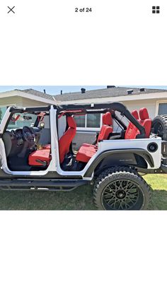 a white jeep with red seats is parked in front of a house