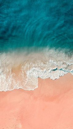 an aerial view of the beach and ocean waves