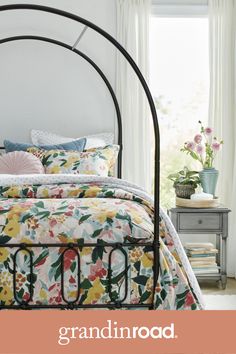 a bed with flowers on it and the words grandinroad written in white