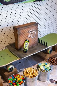 a table topped with buckets filled with candy and candies next to an ice cream stand