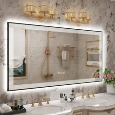 a bathroom with two sinks and a large mirror over it's counter top,