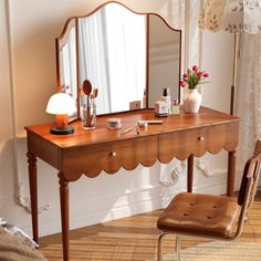 a dressing table with a mirror and stool