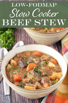 two bowls filled with beef stew on top of a wooden table