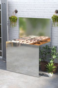 an outdoor area with potted plants and a metal box