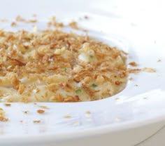 a white bowl filled with food on top of a table