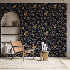 a chair and table in front of a wallpapered room with flowers on it