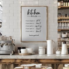 the kitchen rules are displayed above the counter in front of coffee cups and other items