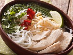 a wooden bowl filled with meat and veggies