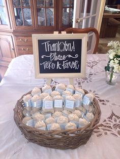 a basket filled with soaps sitting on top of a table next to a sign