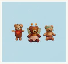 three teddy bears flying in the sky with one bear wearing a hat and another holding a star