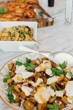 there is a plate of food on the table with other plates and utensils