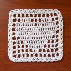 a crocheted dishcloth on a wooden table