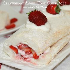 strawberry angel food cake roll with icing and strawberries on the top, ready to be eaten