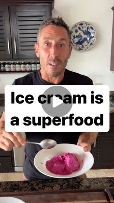 a man holding up a bowl of ice cream in front of his face with the words ice cream is a superfood