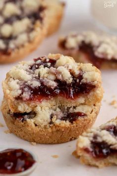 several cookies with jam on them sitting next to each other