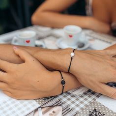 A sentimental and meaningful matching bracelet set for you and your partner. The black and white lava stones represent Ying & Yang - an ancient symbol of harmony and balance, symbolising complementary (rather than opposing) forces that interact to form a dynamic connection. Adjustable size Made from polyester cord and alloy. Includes 2x bracelets (1 white stone & 1 black) Adjustable Black Bracelet For Promise, Adjustable Black Promise Bracelet, Black Adjustable Promise Bracelet, Elegant Black Braided Bracelets For Friendship, Elegant Black Braided Bracelets, Couples' Black Promise Bracelets, Black Couples Bracelet Jewelry, Black Adjustable Couples Bracelets, Elegant Black Friendship Bracelets