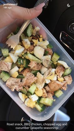 a person holding a fork in a plastic container filled with vegetables and meat, along with the words road snack, bbq chicken, chopped egg egg and cucumber jalapeno seasoning