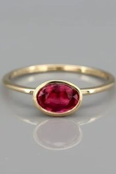 Natural Ruby gold ring, July's Birthstone Ring, Solid 14k Gold Ruby Engagement Ring, Gemstone Ring. A handmade solid 14k gold ring set with a natural rubystone.This ring is a dazzling, solitaire ruby ring. The ruby gem isset in an open bezel exposing the ruby to morelight and increasing it's intensity.The ring was designed with the bezel sitting on top of the ring allowing you to wear it on it's own or to stack it with other rings. Red Ruby Ring In 14k Gold With Bezel Setting, 14k Gold Ruby Ring With Bezel Setting, Yellow Gold Ruby Rings With Bezel Setting, Yellow Gold Solitaire Ruby Rings, 14k Gold Ruby Ring With Round Band, Yellow Gold Solitaire Ring With Ruby, Ruby Ring With Bezel Setting, Round Cut, Classic Ruby Ring With Bezel Setting, Ruby Birthstone Ring In Yellow Gold