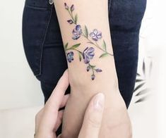 a woman with a flower tattoo on her arm