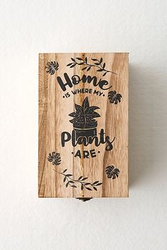 a wooden plaque with the words home is where my plant is