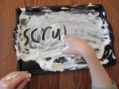 a child is decorating a cake with white frosting and the word scrub on it