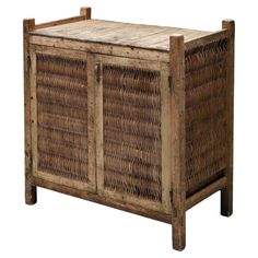 an old wooden cabinet with wicker doors