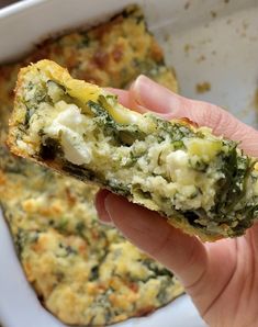 a hand holding up a piece of broccoli and cheese casserole