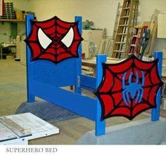 a blue bed frame with a spiderman design on it