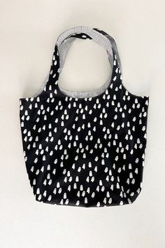 a black and white polka dot bag sitting on top of a table