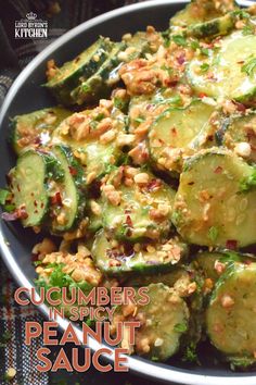 cucumbers in spicy peanut sauce on a plate with the words, cucumbers in spicy peanut sauce