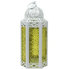 a white and yellow lantern with intricate carvings on the top, hanging from a chain