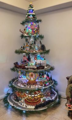 a christmas tree made out of toy trains