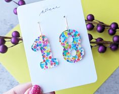 Rainbow Party Dot Earrings, Birthday Number Earrings Celebrate your big day with some colorful birthday number earrings!  These also make a great gift for friends and family! This listing is for ONE pair of number earrings, please leave the desired numbers in the personalization box.  Acrylic earrings on a stainless steel hook. Earrings will be unique to each pair but similar to the ones shown in the photo, we cut each piece from one large sheet of acrylic so the exact pattern slightly varies. Fun Multicolor Earrings For Birthday, Fun Dangle Earrings For Birthday, Playful Multicolor Earrings For Birthday, Fun Personalized Earrings For Birthday, Multicolor Drop Earrings For Birthday, Gold Earrings For Birthday, Personalized Playful Earrings For Birthday, Playful Personalized Earrings For Birthday, Handmade Earrings For Birthday And Mother's Day