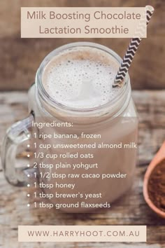 a glass jar filled with chocolate latte on top of a wooden table next to a spoon