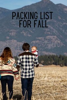 a man and woman walking through a field holding hands with the words packing list for fall