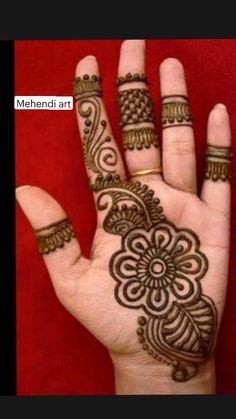 the hand is decorated with henna designs