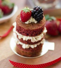 there is a small cake with berries on top