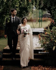 a bride and groom walking down some steps