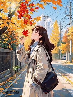 a woman standing on the side of a road while holding onto an orange maple leaf