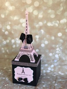 the eiffel tower is made out of black and white paper with a bow on top