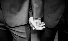 black and white photograph of two people holding hands