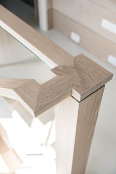 a wooden table with glass top in a room