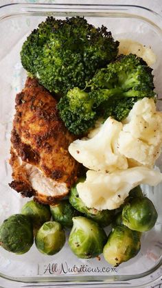 broccoli, cauliflower, and chicken in a glass dish on a table