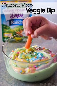 someone is dipping some kind of food into a bowl with confetti and sprinkles