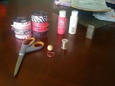 scissors, tape and other crafting supplies on a wooden table next to each other