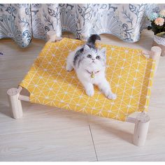 a cat laying on top of a yellow mat